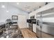 Kitchen featuring granite countertops, stainless steel appliances, and white cabinets at 97 Kettle Harbor Dr, Placida, FL 33946