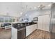 Bright kitchen featuring granite countertops, stainless steel appliances, and white cabinetry at 97 Kettle Harbor Dr, Placida, FL 33946
