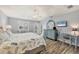Cozy main bedroom with wood floors, light blue walls, and access to a private balcony at 97 Kettle Harbor Dr, Placida, FL 33946