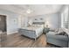 Bright main bedroom with light blue walls, wood floors, and a comfortable sitting area at 97 Kettle Harbor Dr, Placida, FL 33946