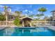 Outdoor pool featuring a swim-up bar with seating, offering a luxurious and relaxing experience in a tropical setting at 97 Kettle Harbor Dr, Placida, FL 33946