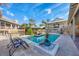Outdoor pool with covered seating area, lounge chairs, and lush landscaping at 97 Kettle Harbor Dr, Placida, FL 33946