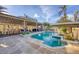 Inviting outdoor pool area features a covered bar and grill, perfect for entertaining and enjoying the Florida sunshine at 97 Kettle Harbor Dr, Placida, FL 33946