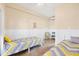Bright bedroom featuring two twin beds, white wainscoting, concrete floors, and a TV on a wicker stand at 97 Kettle Harbor Dr, Placida, FL 33946