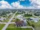 Expansive aerial view of homes in the neighborhood, showcasing lush landscaping and a beautiful blue sky at 10075 Bay Ave, Englewood, FL 34224