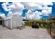 Backyard featuring a shed, picnic table, and grill on a gravel surface at 10075 Bay Ave, Englewood, FL 34224