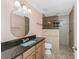 Bathroom with granite countertop, vanity sink and a tiled glass shower at 10075 Bay Ave, Englewood, FL 34224