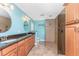 Modern bathroom featuring double sinks, a spacious shower, and bright blue walls at 10075 Bay Ave, Englewood, FL 34224