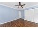 Cozy bedroom with wood floors, closet, and ceiling fan at 10075 Bay Ave, Englewood, FL 34224