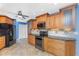 Updated kitchen features wood cabinetry, granite countertops, tile backsplash, and black appliances at 10075 Bay Ave, Englewood, FL 34224