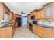 Well-appointed kitchen with wood cabinets, granite countertops, and black appliances at 10075 Bay Ave, Englewood, FL 34224