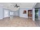 Open-concept living room with tile floors and a view of the kitchen at 10075 Bay Ave, Englewood, FL 34224