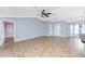 Open living area features tile flooring, a ceiling fan, and plenty of natural light at 10075 Bay Ave, Englewood, FL 34224