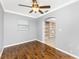 Office with wood-look flooring, fan, and doorway to another room at 10075 Bay Ave, Englewood, FL 34224