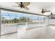 A screened-in pool area with fans and a view of the back yard at 10075 Bay Ave, Englewood, FL 34224
