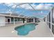 A beautiful kidney-shaped pool with screen enclosure and ample patio space at 10075 Bay Ave, Englewood, FL 34224