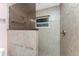 Close up on the shower featuring decorative tiling and mosaic tile floor at 10075 Bay Ave, Englewood, FL 34224