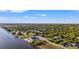 Waterfront lot with easy access to the sea, surrounded by lush greenery, and neighboring residences at 10498 Bay State Dr, Port Charlotte, FL 33981