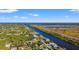 Beautiful view from above of a neighborhood with houses and a long canal that stretches to the ocean at 10498 Bay State Dr, Port Charlotte, FL 33981