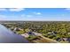 Waterfront lot with easy access to the sea, surrounded by lush greenery, and neighboring residences at 10498 Bay State Dr, Port Charlotte, FL 33981