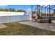 Fenced backyard featuring a patio area with a chair and a bench, plus a grassy area at 10498 Bay State Dr, Port Charlotte, FL 33981