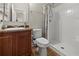 Well-lit bathroom with wood vanity, single sink and tiled floor, features a walk-in shower at 10498 Bay State Dr, Port Charlotte, FL 33981