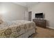Carpeted bedroom featuring a queen bed and wooden dresser with television at 10498 Bay State Dr, Port Charlotte, FL 33981