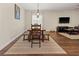Well-lit dining room featuring a wooden table and bench seating with modern decor at 10498 Bay State Dr, Port Charlotte, FL 33981