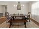 Bright dining area with a wooden dining set and contemporary chandelier at 10498 Bay State Dr, Port Charlotte, FL 33981