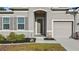 Charming front door with well manicured landscaping and covered front porch at 10498 Bay State Dr, Port Charlotte, FL 33981