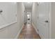 Hallway featuring tile flooring and white doors providing a view into an additional room at 10498 Bay State Dr, Port Charlotte, FL 33981
