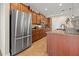 Spacious kitchen featuring stainless steel appliances, wooden cabinets and tile flooring at 10498 Bay State Dr, Port Charlotte, FL 33981