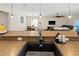 Modern kitchen sink with granite countertops and an open view of the living area at 10498 Bay State Dr, Port Charlotte, FL 33981