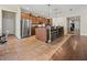 Open-concept kitchen with large island, breakfast bar, stainless steel appliances and tile floors at 10498 Bay State Dr, Port Charlotte, FL 33981