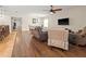 Spacious living room with hardwood floors, a ceiling fan, and an open layout at 10498 Bay State Dr, Port Charlotte, FL 33981