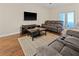 Comfortable living room with a plush sofa, large TV, and stylish decor at 10498 Bay State Dr, Port Charlotte, FL 33981