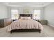 Spacious main bedroom offers plush carpeting, tray ceiling, and large windows with sheer curtains at 10498 Bay State Dr, Port Charlotte, FL 33981
