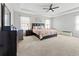 Spacious main bedroom with tray ceilings, carpeted floors, and large windows with plenty of natural light at 10498 Bay State Dr, Port Charlotte, FL 33981