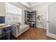 Bright home office with wood floors, a chaise lounge, and built in bookcase at 10498 Bay State Dr, Port Charlotte, FL 33981