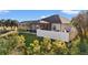 Backyard featuring a screened-in pool and white privacy fence, surrounded by lush landscaping and greenery at 10498 Bay State Dr, Port Charlotte, FL 33981