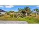 A large landscaped yard with palm trees at 10498 Bay State Dr, Port Charlotte, FL 33981