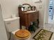 Bathroom with decorative toilet seat and tropical-themed floor mat at 108 Fairway Rd, Rotonda West, FL 33947