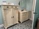 Charming bathroom with custom-painted tile floors, dual vanities, and ample storage space at 108 Fairway Rd, Rotonda West, FL 33947