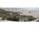 Wide sandy beach with scattered beachgoers and gentle waves, enhanced by natural vegetation at 108 Fairway Rd, Rotonda West, FL 33947
