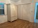 Bright bedroom featuring wood floors, a large wardrobe, and a bi-fold closet door at 108 Fairway Rd, Rotonda West, FL 33947