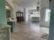 Bright dining area features tile flooring, a large window overlooking the yard, and an elegant chandelier at 108 Fairway Rd, Rotonda West, FL 33947