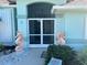 Home exterior featuring a screen door and decorative seahorse statues at 108 Fairway Rd, Rotonda West, FL 33947
