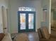 Inviting foyer with etched glass front doors, tiled floors, and views into living spaces at 108 Fairway Rd, Rotonda West, FL 33947
