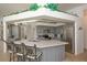 Kitchen features gray cabinetry, stainless steel appliances, marble countertops, and a center island at 108 Fairway Rd, Rotonda West, FL 33947