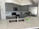 Spacious kitchen featuring modern gray cabinets, stainless steel appliances and an island sink at 108 Fairway Rd, Rotonda West, FL 33947